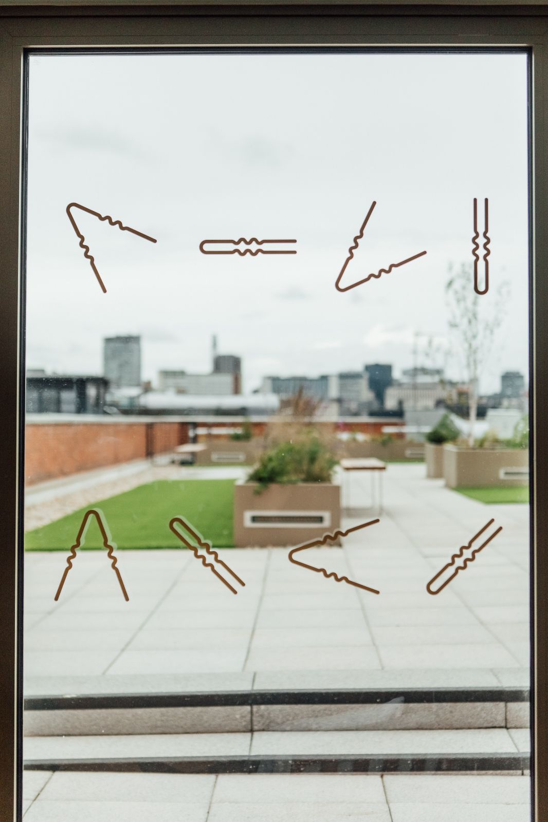 Manifestations of hairpins on the windows. Branding and naming of the building by 93.